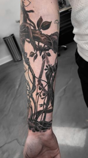 Gifford Kasen's stunning black and gray tree and leaf design for a bold and elegant forearm tattoo.