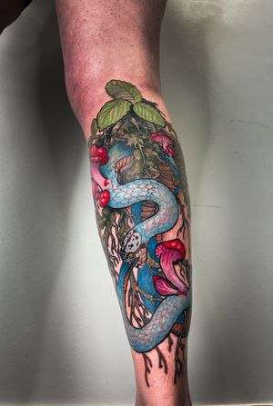 A captivating tattoo featuring a snake, flower, and mushroom, expertly created in an illustrative style by the talented artist Gifford Kasen.