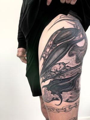 Unique black and gray pattern tattoo on upper leg by Gifford Kasen.