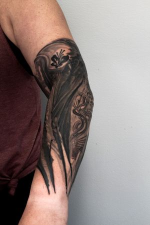 Turn heads with this spine-chilling black and gray horror tattoo by Gifford Kasen, featuring a haunting pattern design.