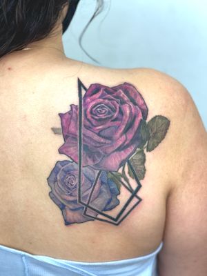 Impressively detailed roses in a geometric style on the upper back by talented artist Gifford Kasen.