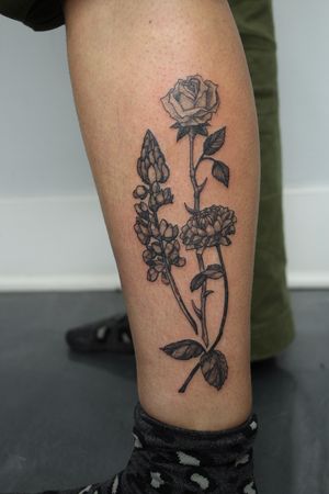 Stunning flower design by Gifford Kasen, perfect for showcasing on your lower leg. Detailed and unique artwork that will surely stand out.