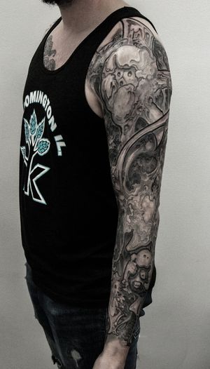 Stunning black and gray sleeve tattoo featuring a mesmerizing pattern, expertly done by Gifford Kasen.