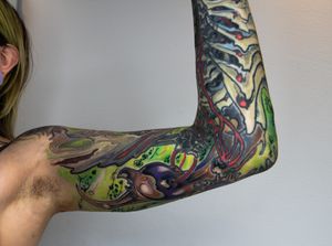 Get intricate and visually striking sleeve tattoo with a unique illustrative pattern by talented artist Gifford Kasen.
