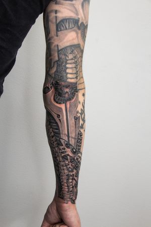 Get a unique illustrative pattern sleeve tattoo by Gifford Kasen, expert in black & gray style.