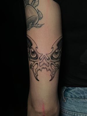 Explore the dark beauty of this black and gray skull tattoo on your forearm by the talented artist Misa.