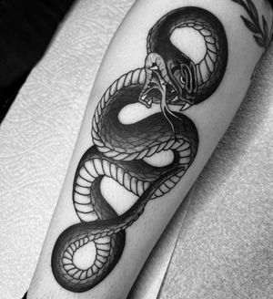 Experience the artistry of Carlos Zucato with this stunning Japanese snake tattoo on your lower leg. Embrace the power and mystery of the serpent in this intricate design.
