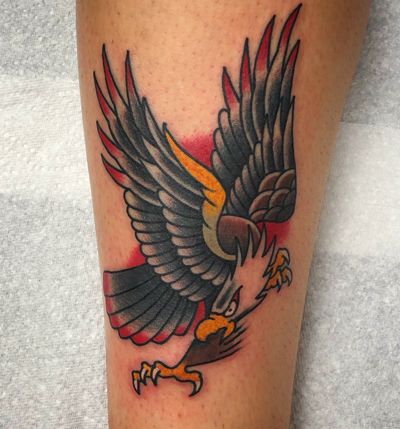 Get a stunning traditional eagle tattoo on your forearm by the talented artist Carlos Zucato. Showcase your strength and freedom with this powerful design.