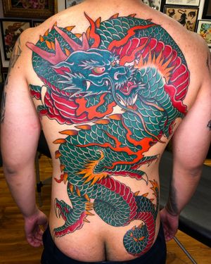 Experience the power of a traditional Japanese dragon tattoo artfully done by Carlos Zucato on your back.