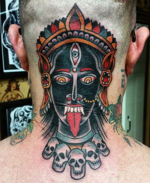 Stunning fusion of traditional and neo-traditional styles by tattoo artist Carlos Zucato, featuring a captivating design of Kali, a girl, and a skull on the neck.