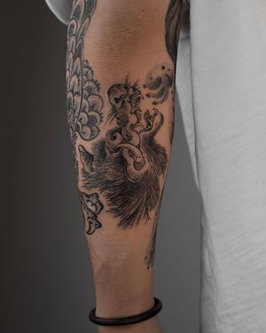Upgrade your forearm with a fierce blackwork wolf design by FKM TATTOO - striking and powerful!