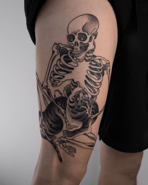 Elegant blackwork and dotwork design showcasing a fierce tiger, skull, and skeleton on upper leg. By FKM TATTOO.