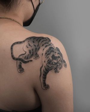Experience the fierce beauty of a black and gray Japanese tiger tattoo with intricate dotwork by FKM Tattoo.