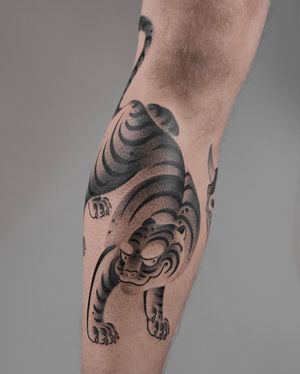 Get a fierce and intricate tiger tattoo in dotwork style by FKM TATTOO. Perfect for those who appreciate Japanese art and symbolism.