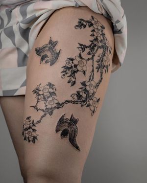 Unique blackwork and illustrative tattoo featuring a bird and cherry blossom motif by FKM TATTOO. Perfect for the upper leg area.