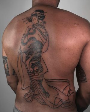 Beautiful black and gray illustrative tattoo on the back featuring a fierce tiger and elegant geisha by FKM TATTOO.