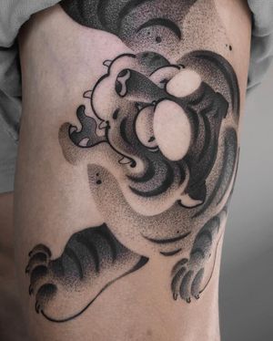 Experience the powerful presence of a black and gray Japanese tiger tattoo, beautifully illustrated by FKM TATTOO.