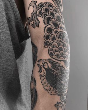 Exquisite black and gray illustrative tattoo featuring a majestic peacock design by FKM TATTOO.