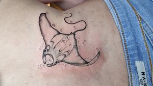 Sting ray fine line tattoo on the lower back