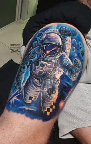 Explore the universe with this stunning new school and realism tattoo of an astronaut and planet on the upper leg by Marek Unfamous Haras.
