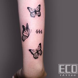 Discover the mesmerizing beauty of Lin Feng's intricate blackwork tattoo featuring a butterfly and a number on the forearm.