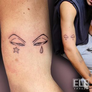 Capture attention with Lin Feng's intricate and captivating fine line eye tattoo on your upper arm.