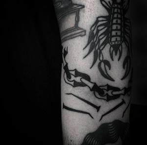Get a sleek and stylish blackwork chain tattoo on your arm, using Jeff Huet's expert fine line technique. Perfect for the edgy and fashion-forward individual.