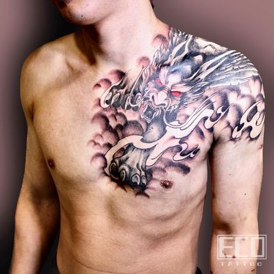 Impressively detailed chest tattoo by Lin Feng featuring a powerful dragon with majestic wings in traditional Japanese style.