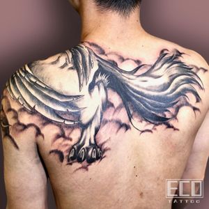 Stunning black and gray dragon wings tattoo on the upper back by Lin Feng. A majestic and powerful design.