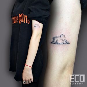 Elegant dotwork clouds gracefully adorn your upper arm in this unique tattoo by artist Lin Feng. Embrace the beauty of simplicity.
