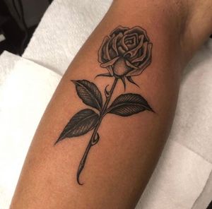 This black and gray fine line tattoo of a beautiful rose on the forearm is a stunning and sophisticated choice for body art. Created by the talented Matty Magee.