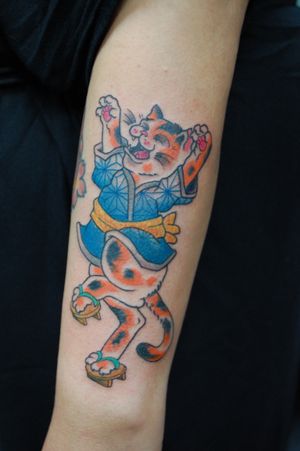 A stunning Japanese style tattoo of a cat on the forearm, expertly done by the talented artist Bananajims. A unique and eye-catching design.