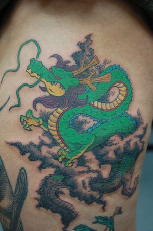 Experience the power and beauty of a Japanese dragon tattoo on your back by renowned artist Bananajims. Embody strength and tradition with this stunning piece of body art.