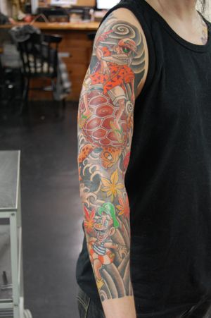 Get a unique sleeve tattoo featuring a Japanese anime style design of a turtle and man by renowned artist Bananajims.