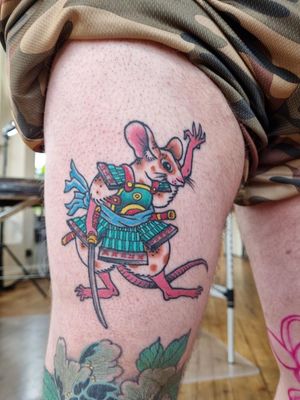 Explore the world of Japanese mythology with this dynamic samurai and rat tattoo on the upper leg. Created by the talented artist Bananajims.