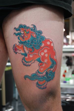 Get a stunning Japanese foo dog tattoo by Bananajims on your upper leg. Embrace the power and protection of this mythical creature.