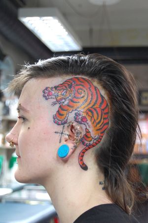 Get a fierce and striking tiger tattoo by Bananajims on your side face. Embrace the power and beauty of this neo traditional design.