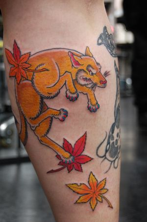 Experience the artistry of Bananajims with this captivating Japanese tattoo featuring a fox and leaf motif on your lower leg.