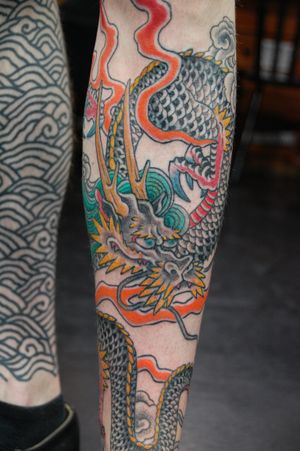 Get a stunning Japanese dragon tattoo on your forearm by the talented artist Bananajims for a bold and striking statement.