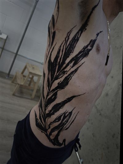 Blackwork rib tattoo by Rachel Aspe featuring a mesmerizing pattern design at Bellatrix Tattoo.