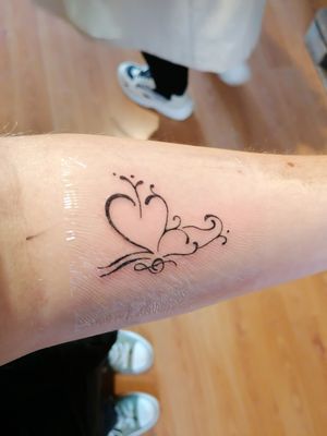 A semicolon butterfly tattoo
