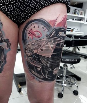 Check out this stunning upper leg tattoo of a car and gauge, done in a realistic style by Marek Unfamous Haras.