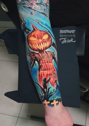 Experience the bold colors and playful design of this new school sleeve tattoo featuring a beautiful flower and whimsical pumpkin, expertly crafted by Marek Unfamous Haras.