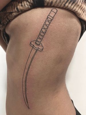 Exquisite fine line sword design by Victor Martin, perfect for adding a touch of strength and elegance to your ribcage.