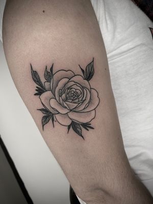 Experience the intricate beauty of a black and gray fine line neo-traditional flower tattoo by Victor Martin.