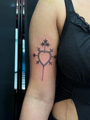 Fine line black and gray tattoo design featuring a delicate heart pierced by a sword, created by artist Misa.