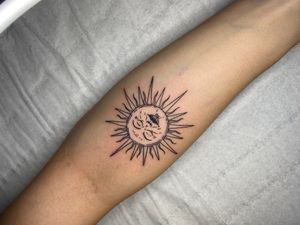 Beautifully intricate sun design on the forearm by Victor Martin, perfect for those who love minimalistic tattoos.