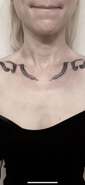 Immerse yourself in the mystique with this black and gray snake design by renowned artist Victor Martin on your shoulder.