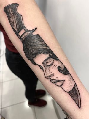 Bold dotwork design by Victor Martin on forearm, featuring a knife and a woman in a neo-traditional style.
