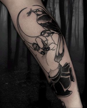 Stunning neo-traditional tattoo featuring a bird and hand design by artist Victor Martin, perfect for lower leg placement.
